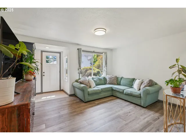 a living room with furniture and a potted plant
