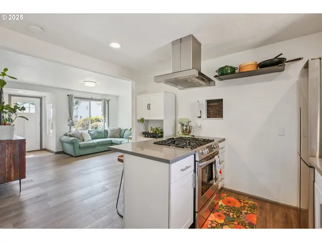a kitchen with stainless steel appliances granite countertop a stove and a refrigerator