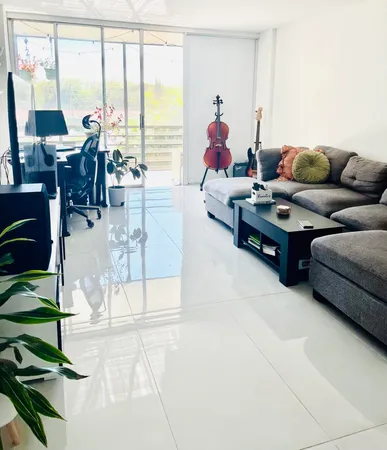 a living room with furniture and a floor to ceiling window
