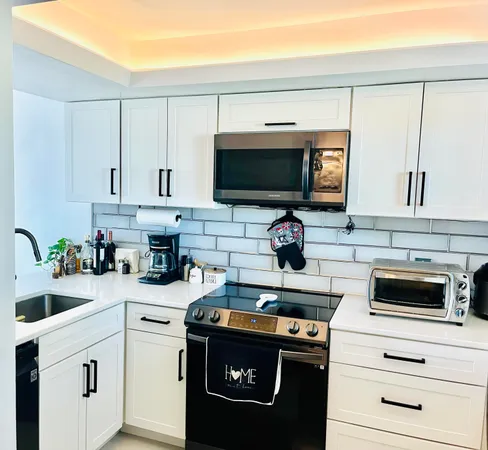 a kitchen with appliances a sink and cabinets