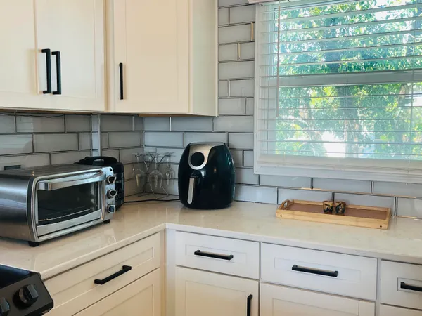 a kitchen with appliances a sink and a cabinets