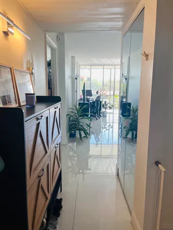 a view of a hallway with furniture