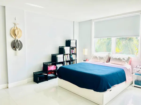 a bedroom with a bed and window