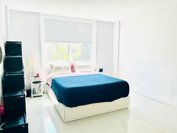 a room with a bed and a window