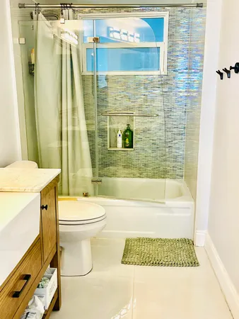 a bathroom with a toilet and a shower