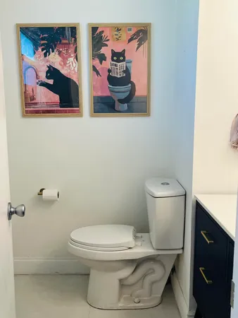 a white toilet sitting next to a bathroom sink