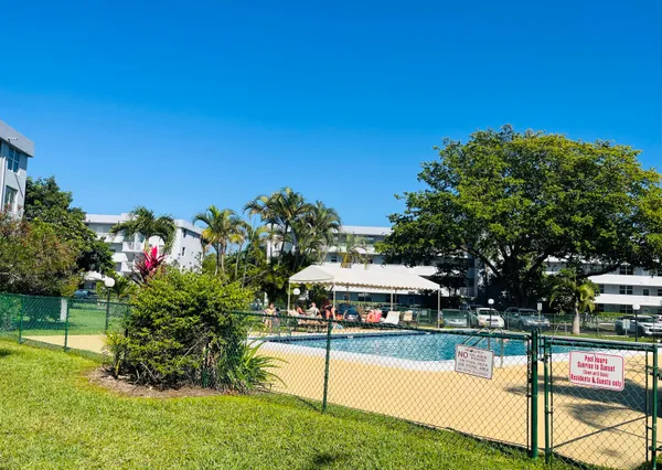 a view of a house with swimming pool and sitting area