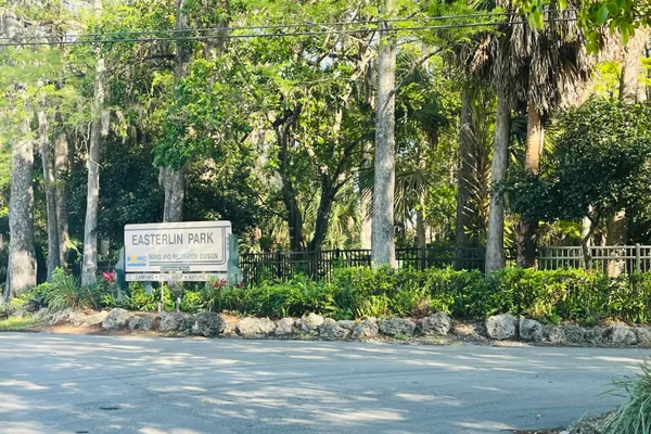 not sign board with potted plants and large trees