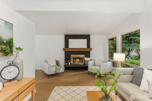 a living room with furniture and a floor to ceiling window