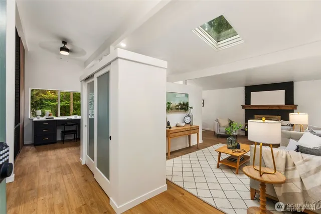 a dining room with furniture a chandelier and wooden floor