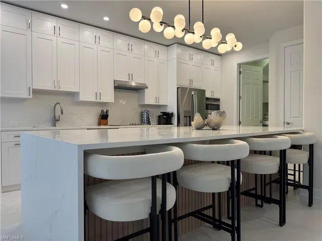 a kitchen with a table and chairs in it