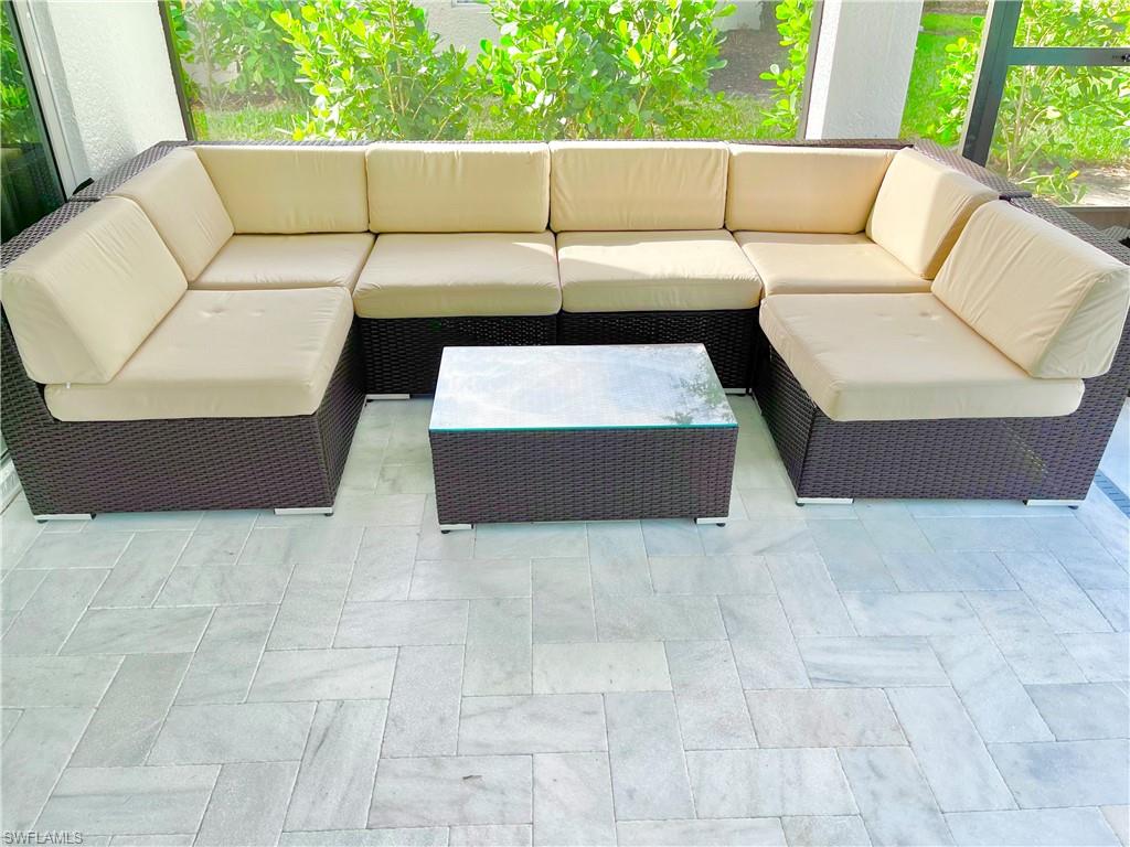 12667 Biscayne Court Naples, FL 34105 - Photo 30 of 41 a living room with furniture and a couch