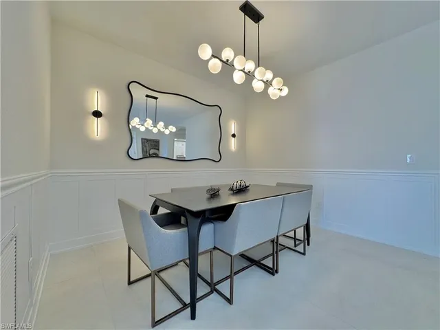 a view of a dining room with furniture and chandelier