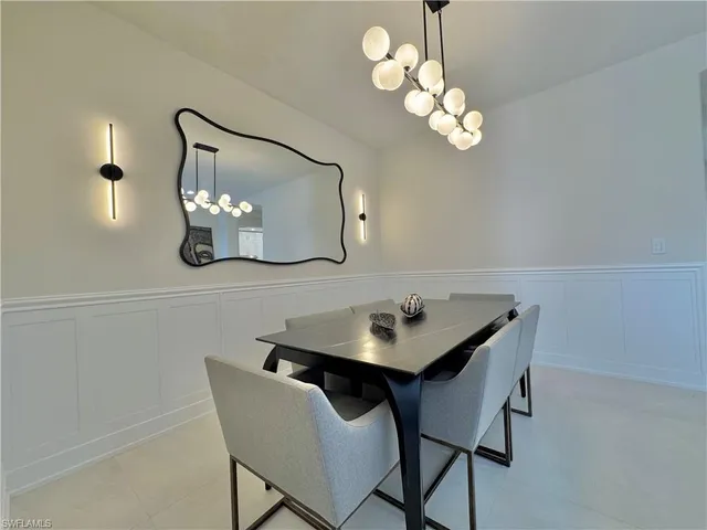 a view of a dining room with furniture and chandelier