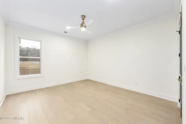 an empty room with closet and windows