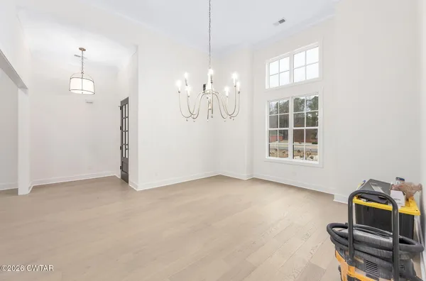 an empty room with windows and entrance