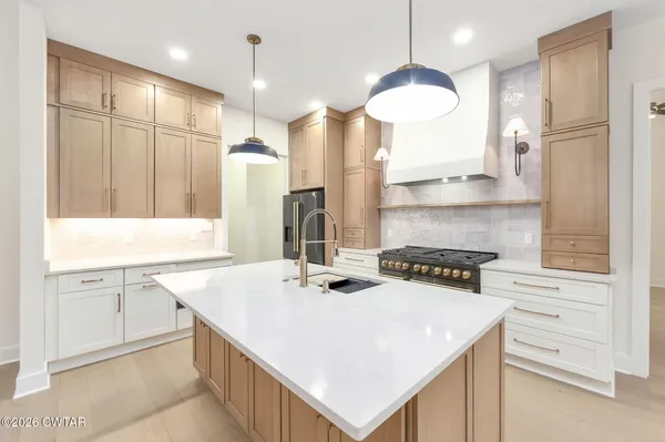 a kitchen that has a cabinets a sink and a stove