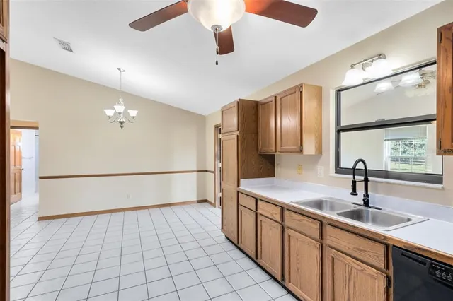 a kitchen with a sink refrigerator and cabinets