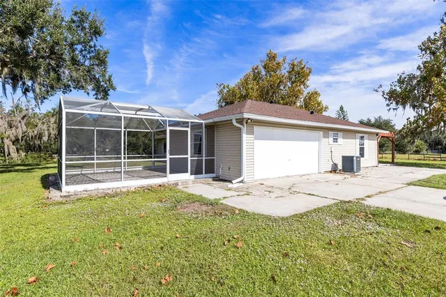 a view of a house with backyard and sitting area