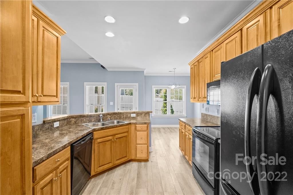 402 Ellicott Lane Locust, NC 28097 - Photo 13 of 41 a kitchen with stainless steel appliances granite countertop a sink a stove and refrigerator