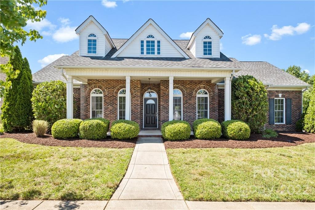 402 Ellicott Lane Locust, NC 28097 - Photo 2 of 41 a view of a brick house with potted plants