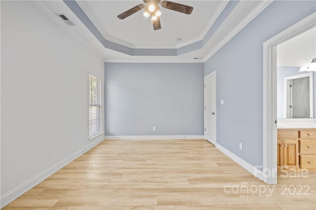 402 Ellicott Lane Locust, NC 28097 - Photo 21 of 41 a view of an empty room with a chandelier fan
