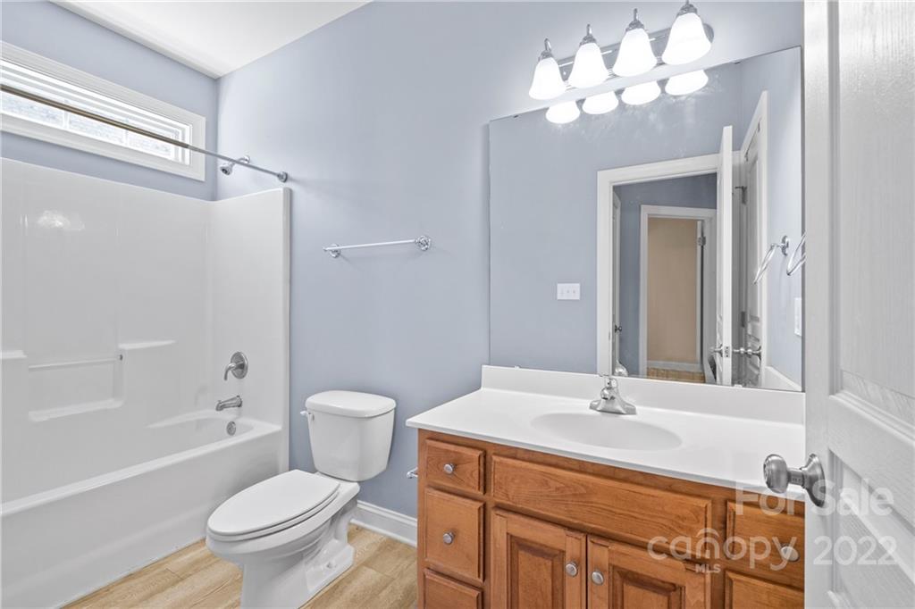 402 Ellicott Lane Locust, NC 28097 - Photo 27 of 41 a bathroom with a toilet a sink a mirror and a bathtub