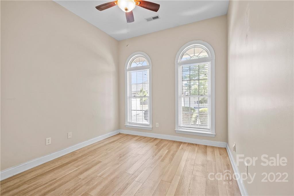 402 Ellicott Lane Locust, NC 28097 - Photo 28 of 41 an empty room with wooden floor chandelier fan and window