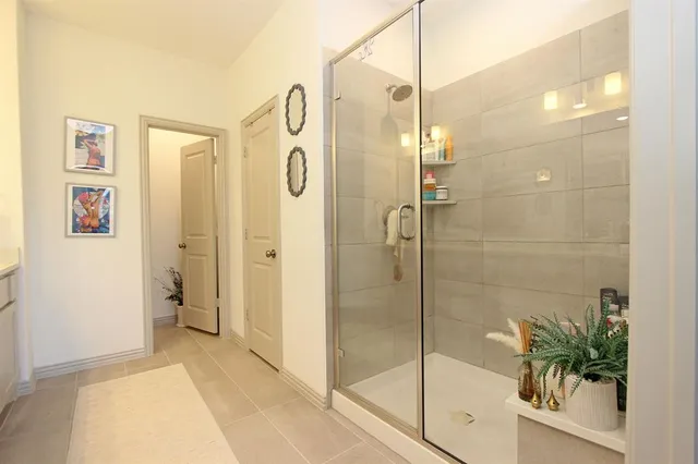 a spacious bathroom with a double vanity sink mirror and shower