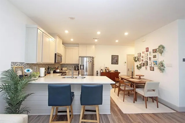 a living room with furniture a flat screen tv and a table