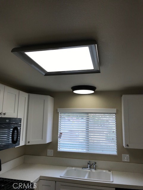 4261 Cedar Drive, Unit 10 San Bernardino, CA 92407 - Photo 11 of 15 a view of kitchen with a sink and cabinets