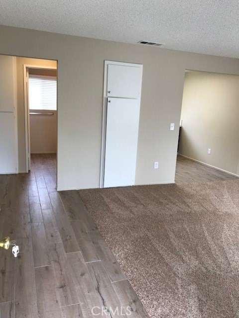 4261 Cedar Drive, Unit 10 San Bernardino, CA 92407 - Photo 4 of 15 a view of an empty room and wooden floor