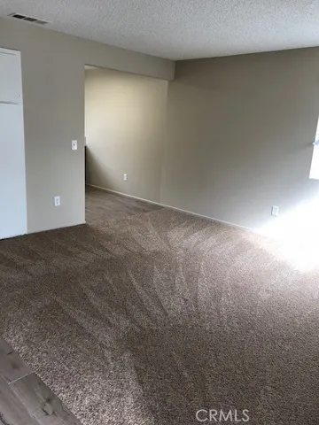 an empty room with wooden floor and closet