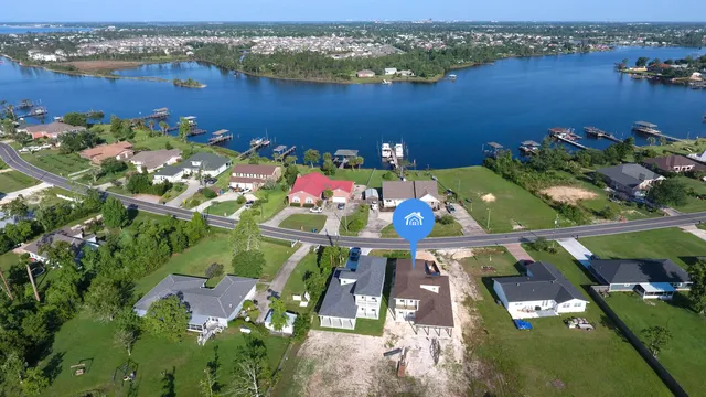 an aerial view of a residential houses with outdoor space and swimming pool