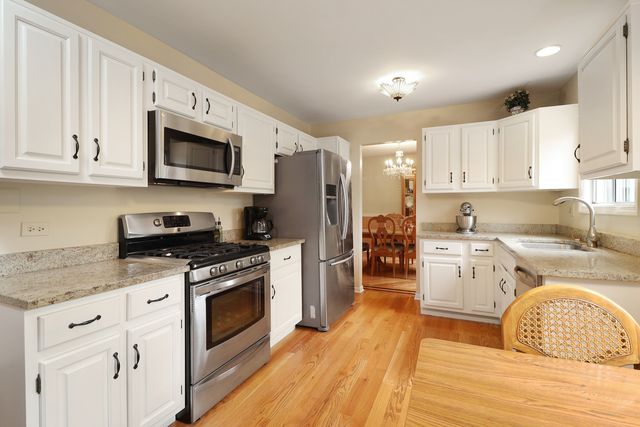 a kitchen with a stove a sink and a microwave