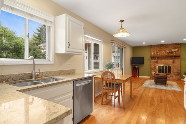 a view of a dining room with furniture a chandelier and wooden floor