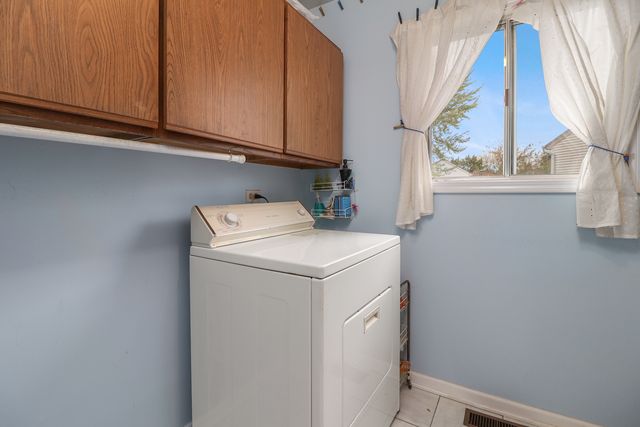 a front view of a house with garden and sitting area
