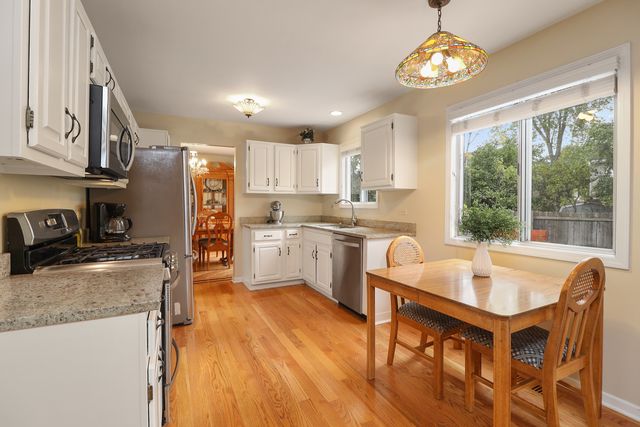 a kitchen with a sink appliances and cabinets