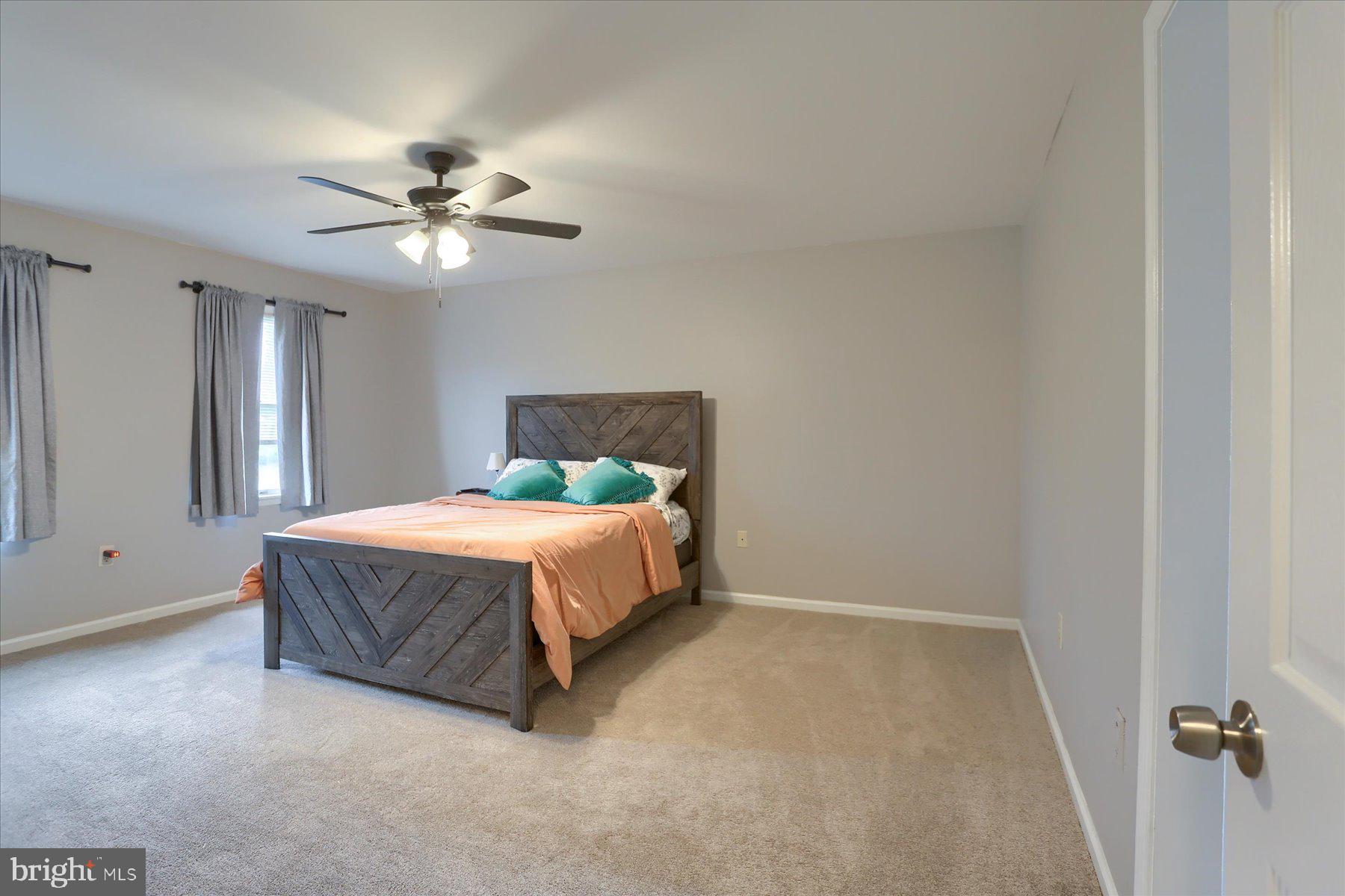 3704 Reichert Road Harrisburg, PA 17110 - Photo 18 of 44 a spacious bedroom with a bed and a chandelier