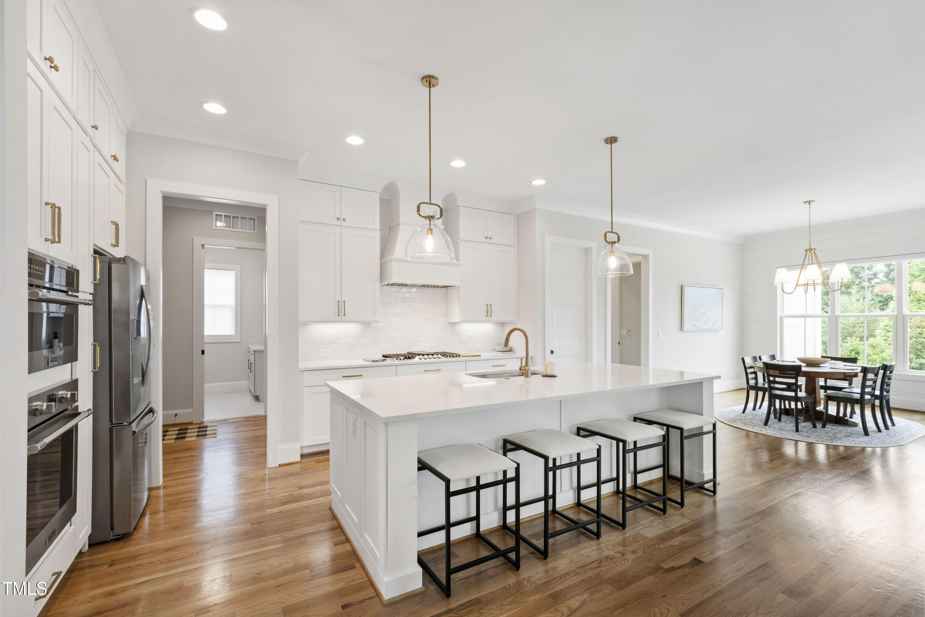 912 Lily Claire Lane Fuquay-Varina, NC 27526 - Photo 17 of 64 a large kitchen with a table and chairs