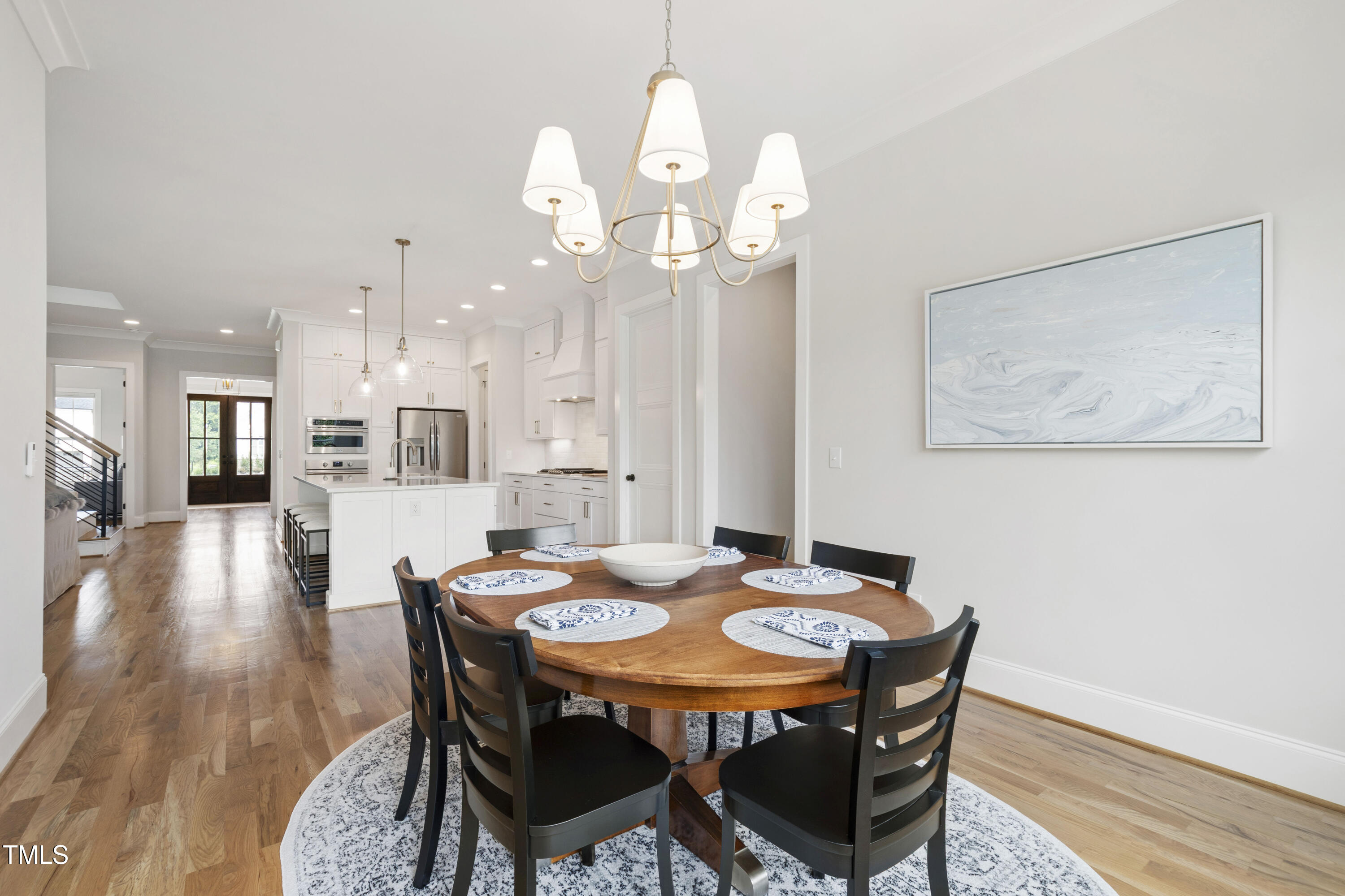 912 Lily Claire Lane Fuquay-Varina, NC 27526 - Photo 18 of 64 a view of a dining room with furniture and wooden floor
