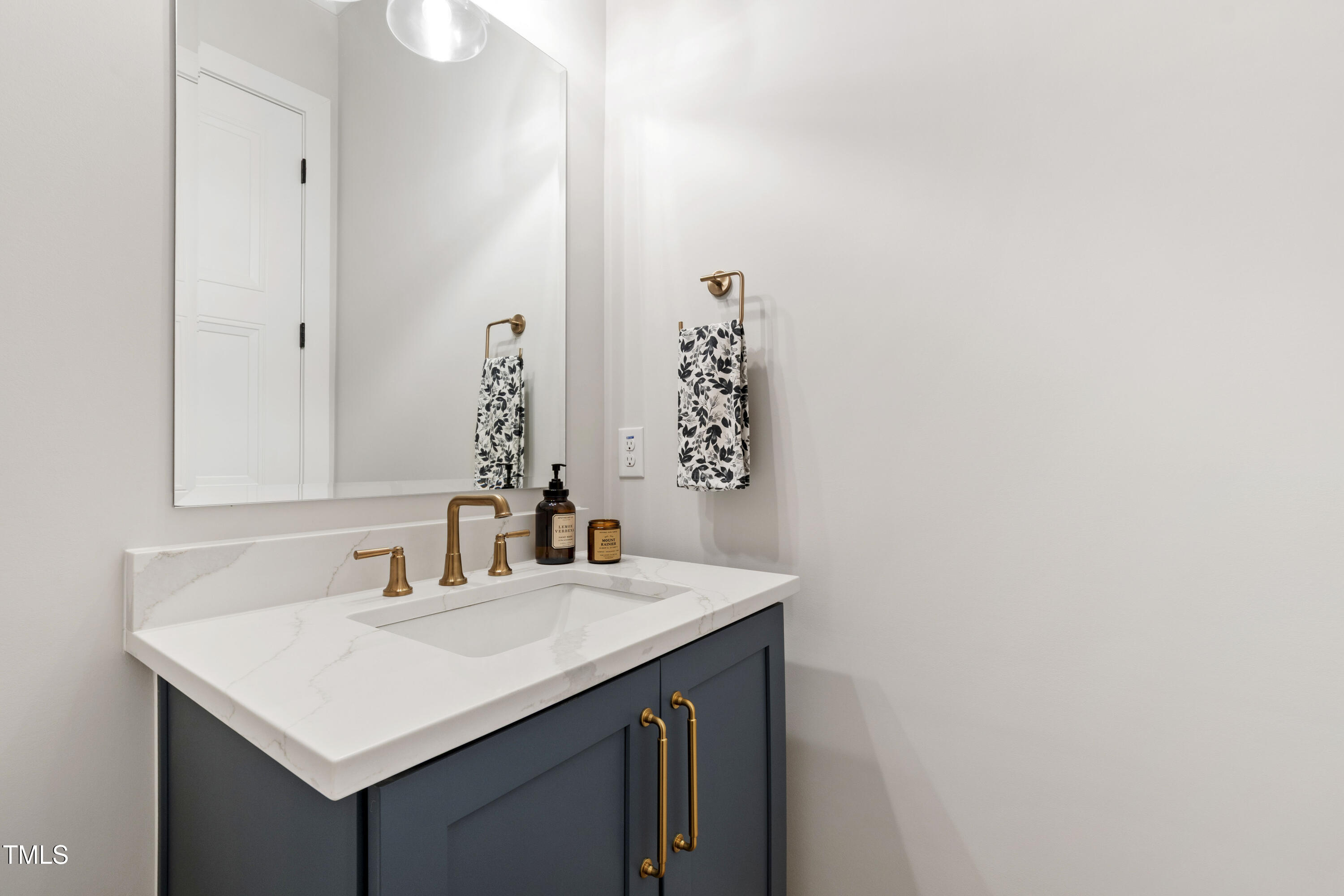 912 Lily Claire Lane Fuquay-Varina, NC 27526 - Photo 22 of 64 a bathroom with a sink and a mirror