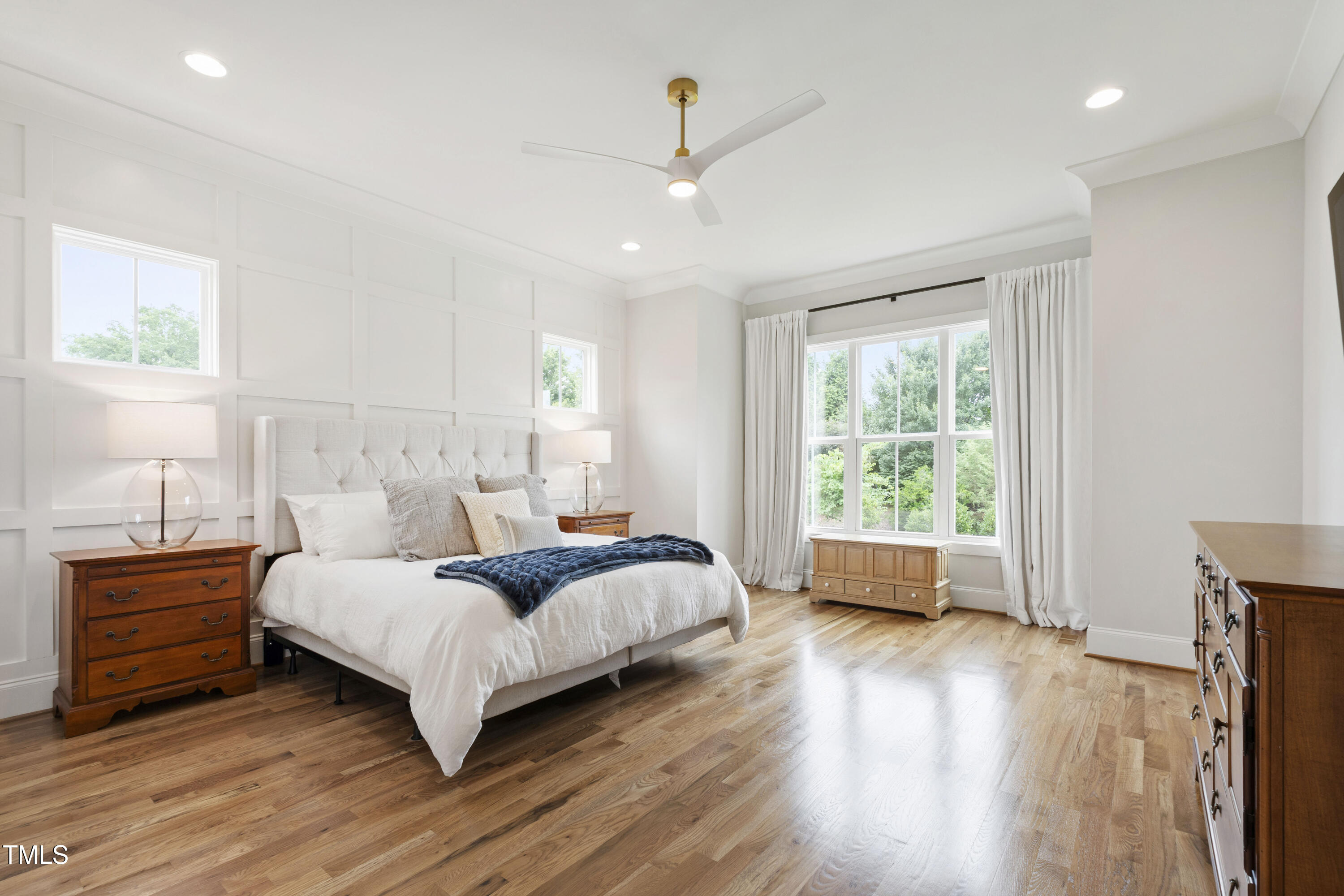 912 Lily Claire Lane Fuquay-Varina, NC 27526 - Photo 27 of 64 a bedroom with a large bed and a wooden floor