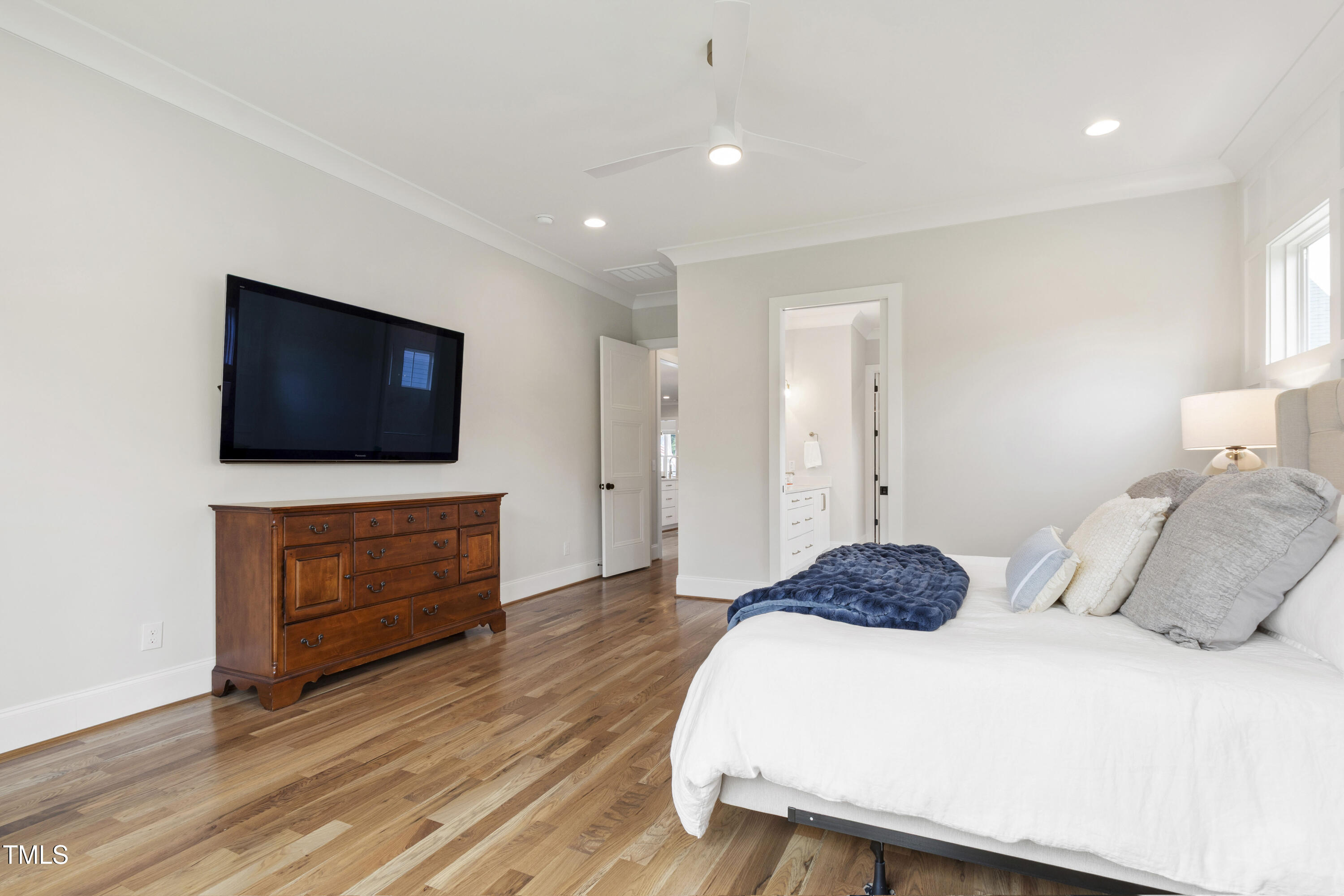 912 Lily Claire Lane Fuquay-Varina, NC 27526 - Photo 28 of 64 a bedroom with a bed and a flat screen tv