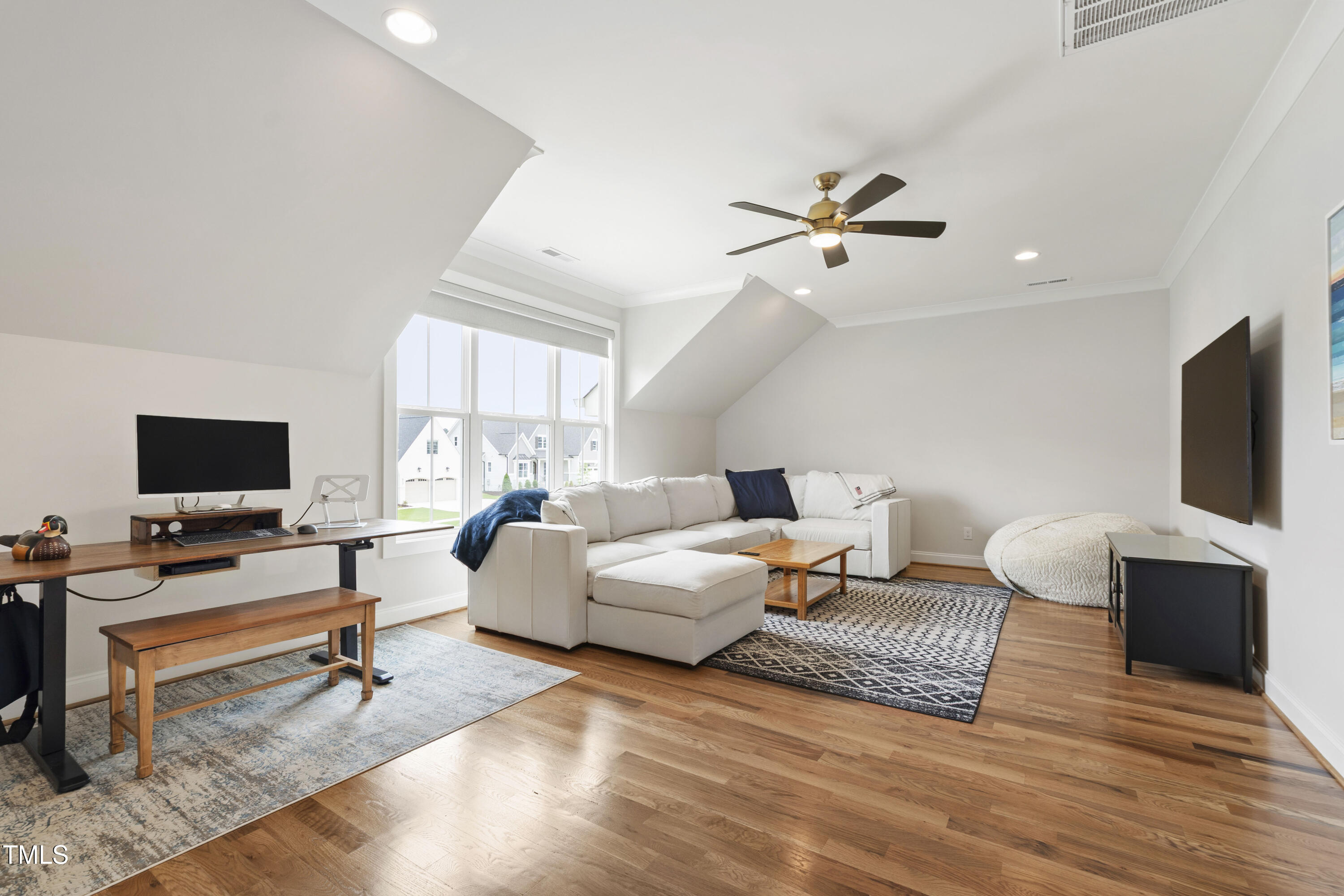 912 Lily Claire Lane Fuquay-Varina, NC 27526 - Photo 41 of 64 a living room with furniture and a flat screen tv
