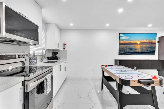 a kitchen that has a lot of cabinets in it and appliances