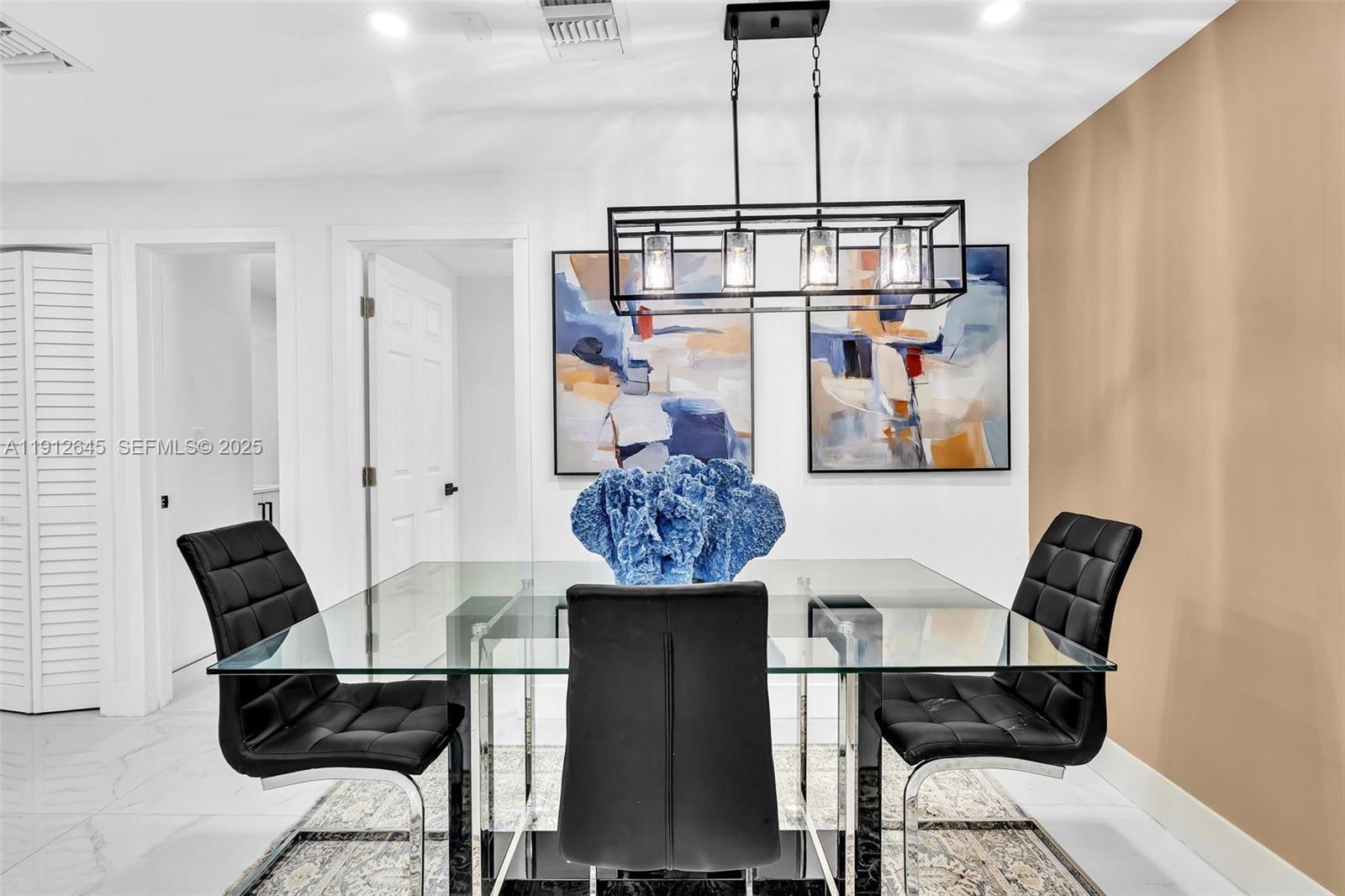 923 Northwest 110th Street, Unit A Miami, FL 33168 - Photo 16 of 21 a view of a dining room with furniture and chandelier