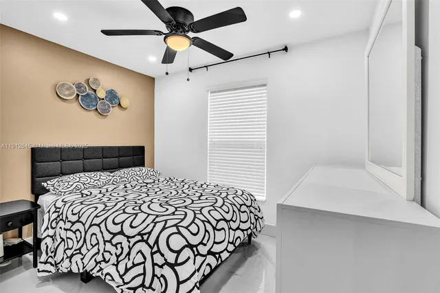 a bedroom with a bed and a painting on the wall