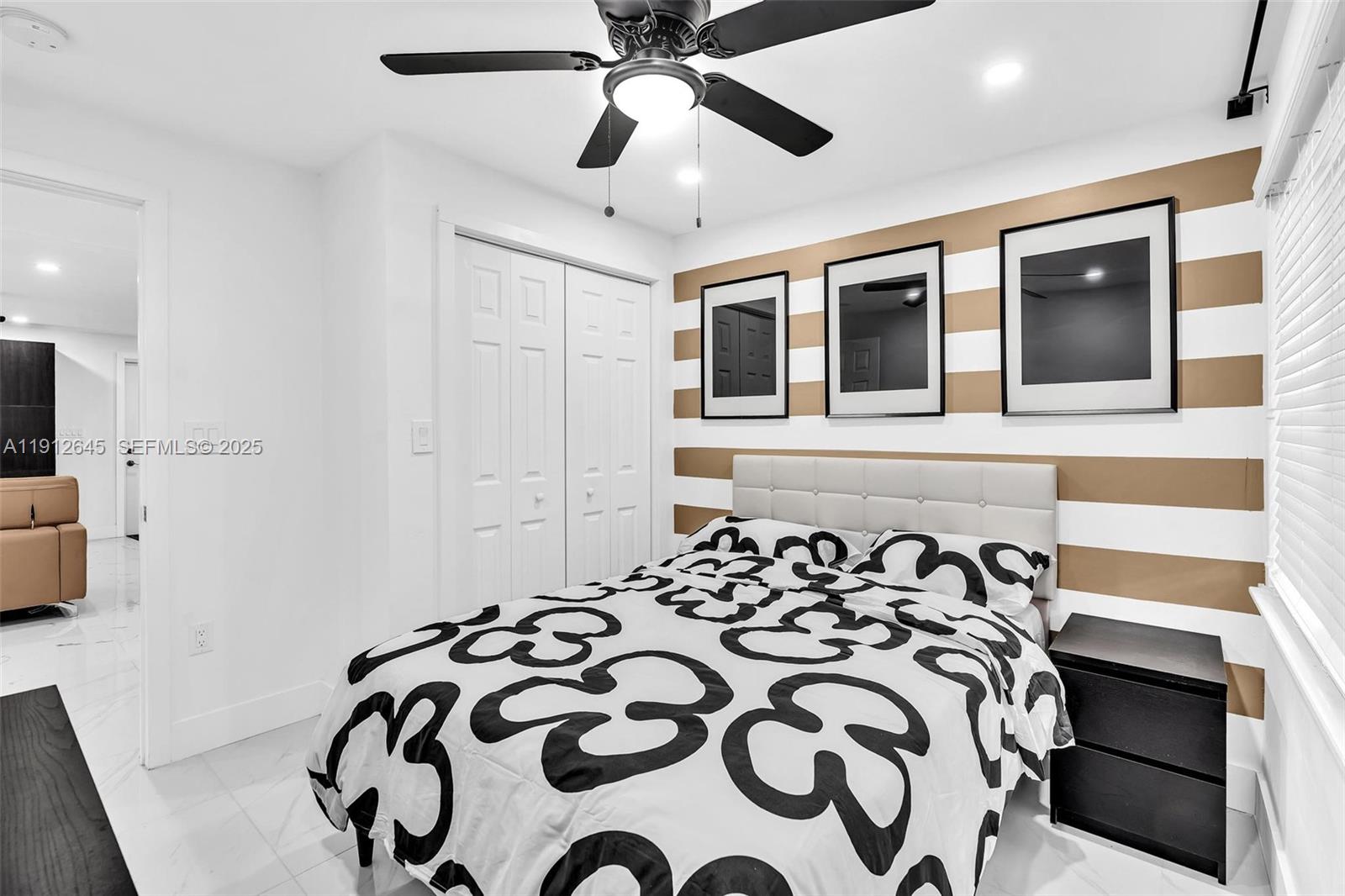 923 Northwest 110th Street, Unit A Miami, FL 33168 - Photo 19 of 21 a bedroom with a bed and a chandelier