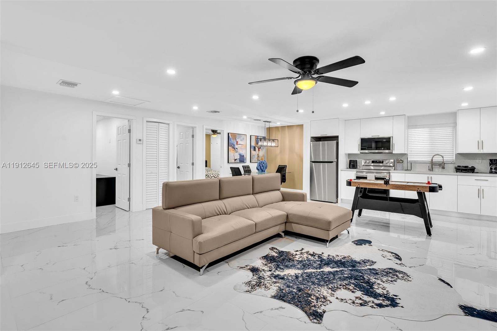 923 Northwest 110th Street, Unit A Miami, FL 33168 - Photo 3 of 21 a living room with furniture and kitchen view